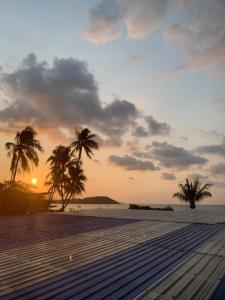 a sunset on a beach with palm trees on it at DD Bangrak Hotel in Koh Samui