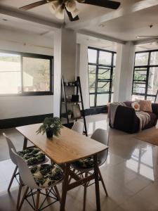 a living room with a table and chairs and a couch at El Kim Suites in Boac