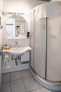 a bathroom with a shower and a sink at AlpenParks Hotel Maria Alm in Maria Alm am Steinernen Meer +60 photos