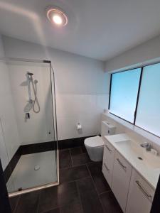 a bathroom with a shower and a toilet and a sink at The Rec Hotel Waroona in Waroona