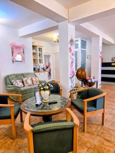 a living room with a table and chairs at Pensiunea Emma in Sâmbăta de Sus