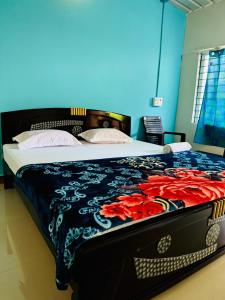 a bedroom with a bed with a blue wall at Junglee tree stays in Hampi