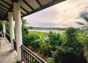 a balcony of a house with a view of a field at Ehana holiday in Tangalle