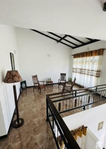 a living room with chairs and a lamp at Ehana holiday in Tangalle