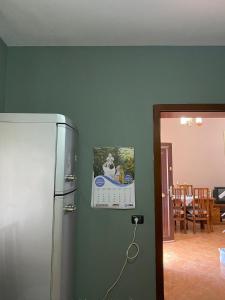 a refrigerator in a kitchen with a picture on the wall at Kroi'Pistolve in Krujë