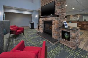 a lobby with a fireplace and a flat screen tv at Hampton Inn and Suites St. Cloud in Saint Cloud