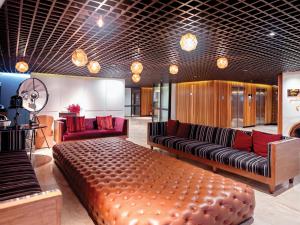 a living room with a large couch and red furniture at DoubleTree by Hilton Sukhumvit Bangkok in Bangkok +66 photos