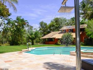 a swimming pool in a yard with a house at Onça 1024 in Trancoso