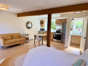 a living room with a couch and a table at Tofino Trailhead in Tofino