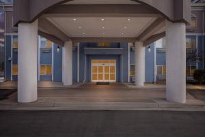 a front door of a building with columns and a yellow door at Comfort Inn Ogden near Event Center in Ogden