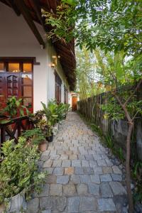 a stone walkway next to a building with plants at Banyan Villa Nha Trang in Nha Trang