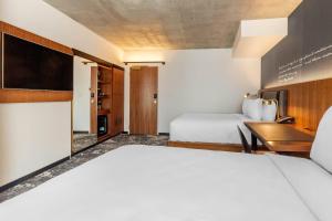 a hotel room with a bed and a desk at Cambria Hotel Boston Downtown - Seaport in Boston