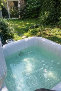 a hot tub with water in a backyard at Spa Sauna et jardin 47m2 Cosy hyper centre in Boulogne-sur-Mer