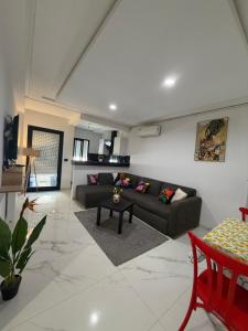 a living room with a couch and a table at Premium Suite - Ain zaghouen - proche aeroport - linge hotel in El Aouina Station +19 photos