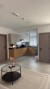 a large living room with a table and a kitchen at Al Azaiba apartment in Muscat +6 photos