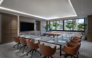 a conference room with tables and chairs and a flat screen tv at Doubletree By Hilton Istanbul Macka in Istanbul