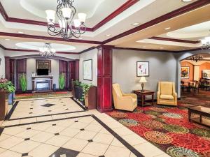 a lobby of a hotel with chairs and a fireplace at Country Inn & Suites by Radisson, Terrell in Terrell