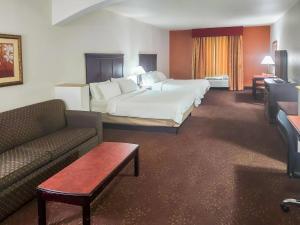 a hotel room with a bed and a couch at Country Inn & Suites by Radisson, Terrell in Terrell