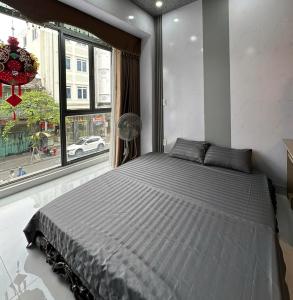 a large bed in a room with a window at Phốstay 180 Cầu Đất in Hai Phong