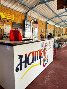 a long counter with a harma sign on it at Junglee tree stays in Hampi +28 photos