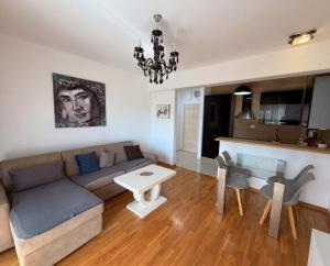 a living room with a couch and a table at Status S in Bečići
