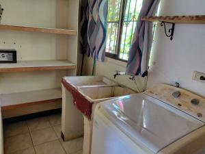 a kitchen with a washing machine in a room at Cahuita Lodge in Cahuita +42 photos