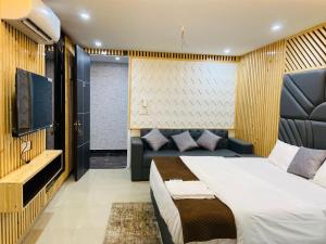 a bedroom with a bed and a couch at The Warmwood Studio in Dehradun