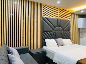 a bedroom with a large bed and a chair at The Warmwood Studio in Dehradun