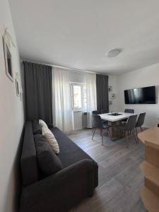 a living room with a couch and a table at Apartments Vukovic in Selce