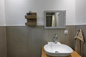 a bathroom with a sink and a mirror at Palataki in Epanomi