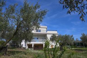 a white house with trees in front of it at Palataki in Epanomi
