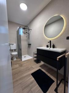 a bathroom with a sink and a mirror and a toilet at Apartments Vukovic in Selce +19 photos