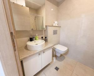 a bathroom with a sink and a toilet at Status S in Bečići +10 photos