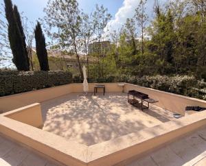 a large patio with a table and a bench at Status S in Bečići