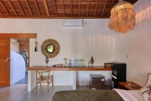 a living room with a desk and a table at Bayrin Private Villas in Nusa Penida