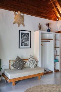 a living room with a couch with pillows on it at Bayrin Private Villas in Nusa Penida
