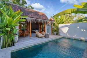 a villa with a swimming pool and a house at Bayrin Private Villas in Nusa Penida