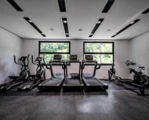 a gym with treadmills and bikes in a room at Status S in Bečići