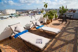 two chairs on the roof of a building at Dar El Kébira in Rabat