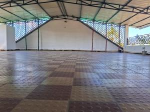 an empty room with a large floor and a staircase at The Rustic Inn Kaziranga in Kāziranga