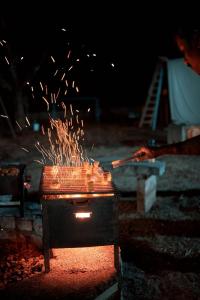 a bunch of sparks are coming out of a stove at The Temple Tree Residence in Yelagiri