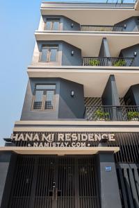 a building with a sign that reads hamana nuc refugees resettlement at Hanami Residence - Self Check-in Accommodation in Danang +22 photos
