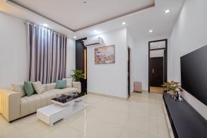a living room with a couch and a tv at Hanami Residence - Self Check-in Accommodation in Danang