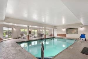 a large swimming pool with a tv in a building at Comfort Inn & Suites Suwanee - Sugarloaf in Suwanee