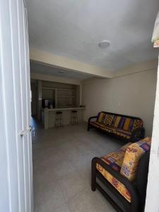 a living room with two beds and a kitchen at Apartamento Turiksa in Acapulco