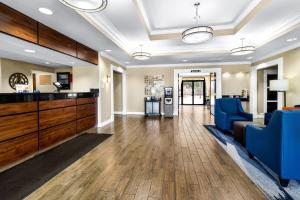 a lobby with blue chairs and a waiting room at Comfort Inn Evansville East in Evansville