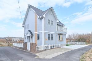 a white house with a white fence at Villa上条 名古屋から30分本格ガスグリルでBBQができる宿 in Kasugai
