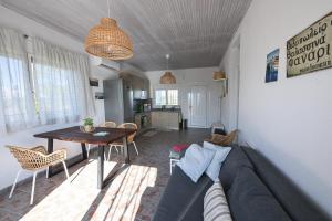 a living room with a couch and a table at Summer house Spiti Pirgos in Epanomi