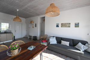 a living room with a couch and a table at Summer house Spiti Pirgos in Epanomi +16 photos