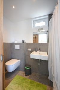 a bathroom with a sink and a toilet and a window at Summer house Spiti Pirgos in Epanomi